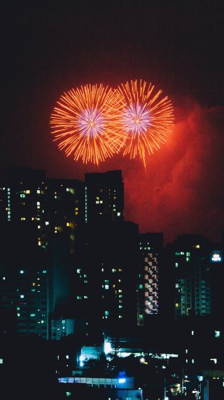 Fireworks over buildings Wallpaper