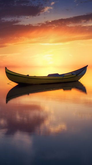 Boat in the middle of lake at sunset Wallpaper